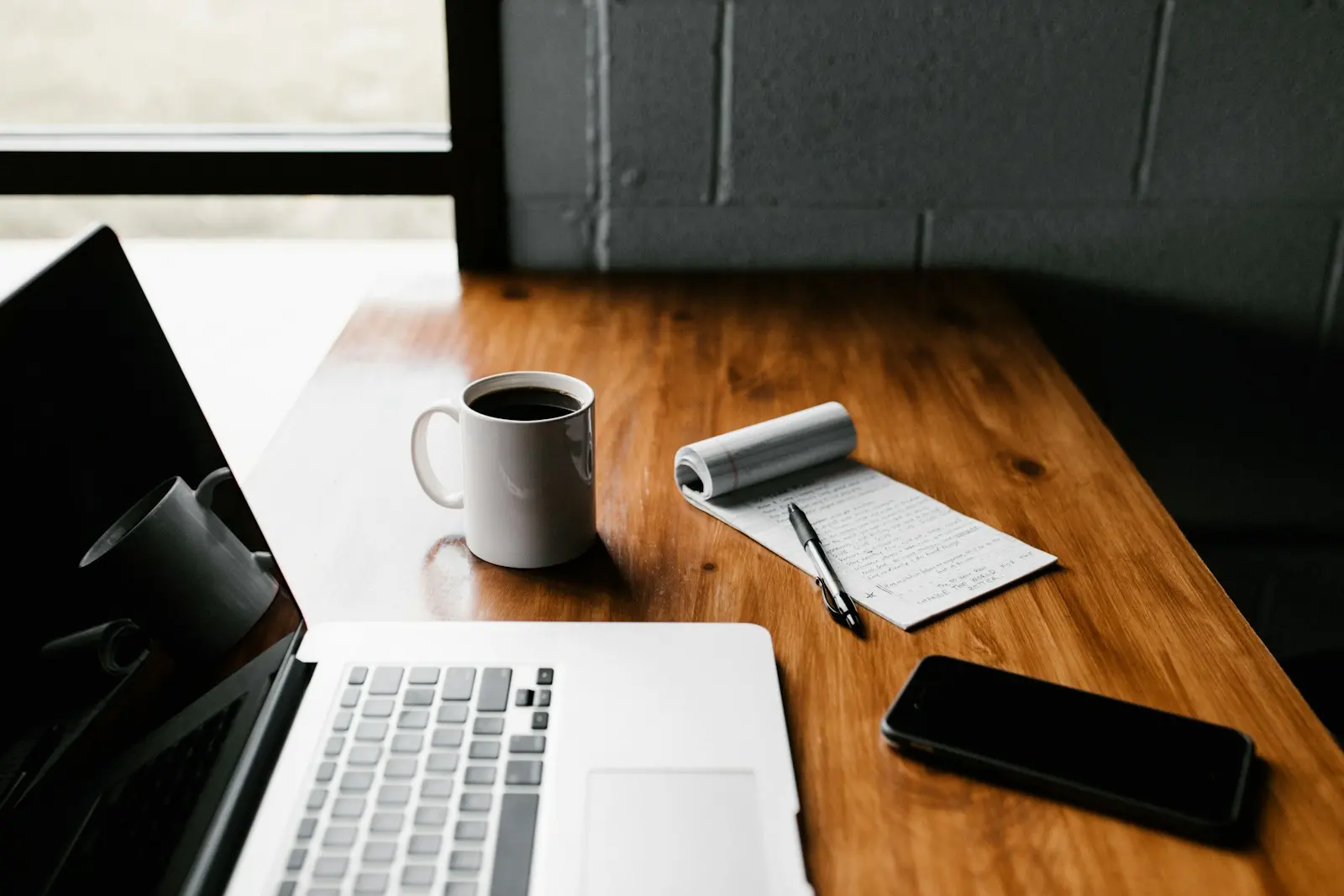 A laptop on a wooden desk