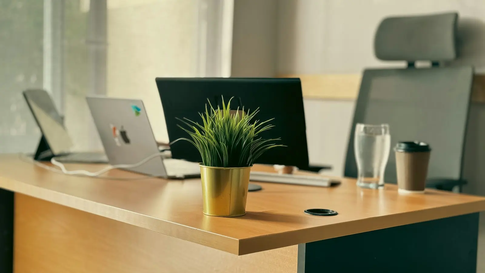 A desk with a laptop in a property management office