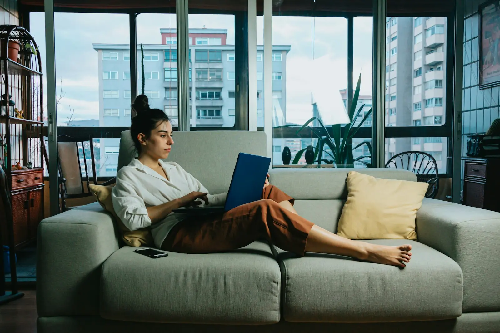 A property owner on a sofa with a laptop